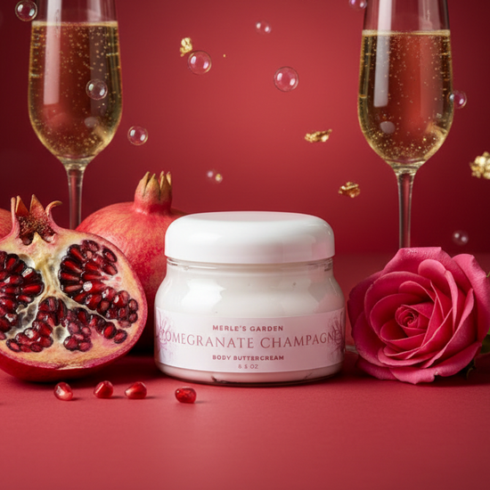 Jar of 'Pomegranate Champagne' body butter cream with two glasses of champagne, a pink rose, and a pomegranate on a red background.