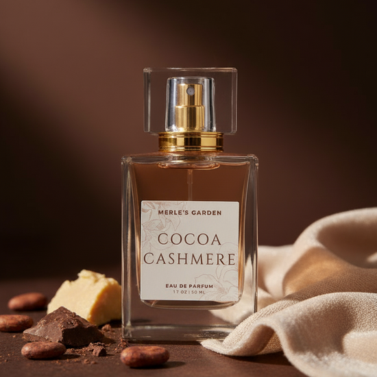 Perfume bottle labeled 'Cocoa Cashmere' with chocolate and cashew nuts on a dark background